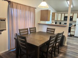 a dining room with a wooden table and chairs at Central Comfort Duplex in Moses Lake