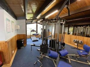 a gym with several tread machines and blue chairs at Ruby'scumbrianholidaysforall SEN friendly in Carlisle