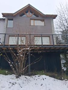 a house with snow in front of it at Casa Tinta in San Carlos de Bariloche