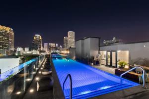 a swimming pool on top of a building with a city skyline at Corner Penthouse w Private Balcony Hotel Suite in New Orleans