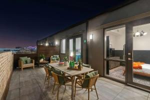 a patio with a table and chairs and a bedroom at LUX Suite Rooftop Pool Workspace Games Hotel in New Orleans