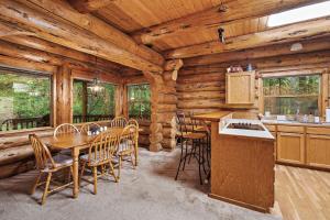 a kitchen and dining room in a log cabin at Creekside Log Cabin - Fireplace - Mt Hood in Mount Hood Village