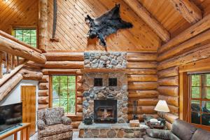a living room with a fireplace in a log cabin at Creekside Log Cabin - Fireplace - Mt Hood in Mount Hood Village +37 photos