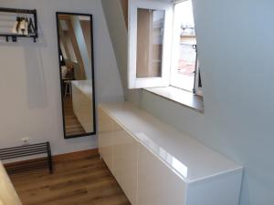 a white hallway with a window and a mirror at Oporto apartment Batalha in Porto