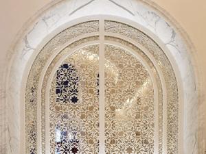 an ornate glass door in a building at Raffles Doha in Doha
