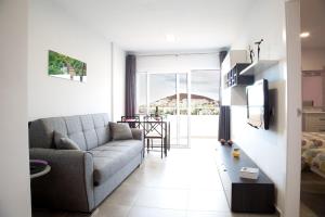 a living room with a couch and a table at Amazing sea view in Los Cristianos in Los Cristianos