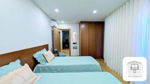 a hotel room with two beds and a window at Casa do Avô Gonçalo in Mogadouro +35 photos