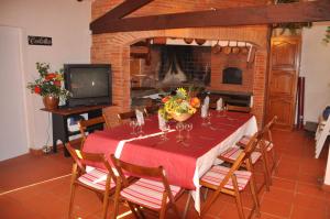 a dining room with a table and a fireplace at Domaine de Hurlevent in Montgaillard-Lauragais