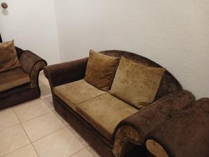 a couch and a chair in a room at قصر أبها للشقق المفروشة in Abha