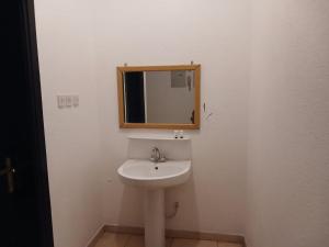 a bathroom with a sink and a mirror at قصر أبها للشقق المفروشة in Abha