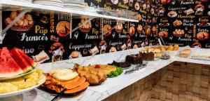 a buffet with a lot of different types of food at Pousada Estrela Dourada in João Pessoa