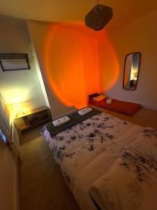 a bedroom with a bed and a room with a mirror at Central Stay in Southampton