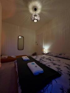 a bedroom with a bed with towels on it at Central Stay in Southampton