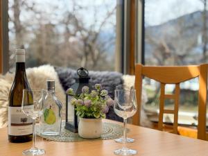 a table with two bottles of wine and glasses at Salburg Tröpolach in Tröpolach