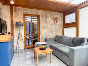 a living room with a couch and a table at Salburg Tröpolach in Tröpolach