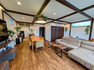 a living room with a couch and a table at Kawaguchiko Villa LaLuce in Fujikawaguchiko