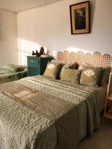 a bedroom with a large bed with a blanket at Encanto da Paz in Miracatu