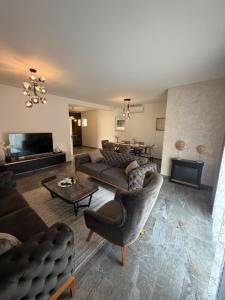 a living room with couches and a couch and a table at AD Homes in Ravanj