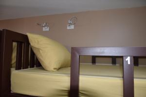 a bunk bed with a yellow pillow on top of it at Like Home in Bangkok