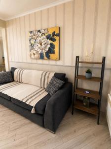 a couch sitting in a living room with a table at Luxury & Modern Apartment in Paralia Katerinis