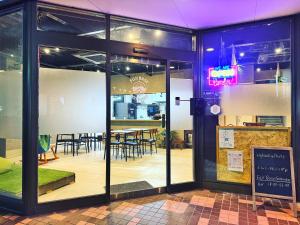 a restaurant with a dining room with tables and chairs at 富士Base御殿場 Station-Side in Gotemba