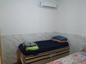 a bed in a room with two pillows on it at casa 3 perto Carapina grande a 08 kilometros do aeroporto in Serra
