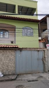 a house with a metal gate in front of it at casa 3 perto Carapina grande a 08 kilometros do aeroporto in Serra