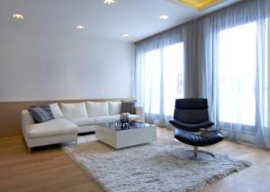a living room with a white couch and a chair at Casa lunar in Belfort Roxo