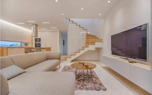 a living room with a couch and a tv and stairs at Casa lunar in Belfort Roxo
