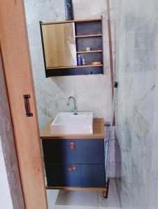 a bathroom with a sink and a mirror at casa 3 perto Carapina grande a 08 kilometros do aeroporto in Serra +62 photos