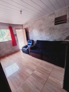 a living room with a couch and a chair at casa 3 perto Carapina grande a 08 kilometros do aeroporto in Serra