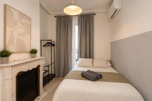 a bedroom with two beds and a fireplace at Matute Street, Private rooms in Madrid