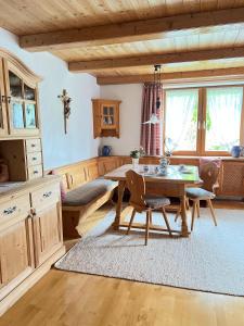 a kitchen with a table and chairs in a room at Ferienwohnungen Irmengard in Bernau am Chiemsee