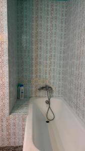 eine Badewanne in einem Badezimmer mit Spiegel in der Unterkunft Hostal Parada in Viladecáns
