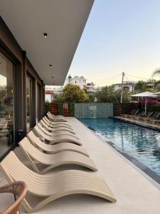 a row of books lined up next to a swimming pool at Monun Hotel in Ksamil