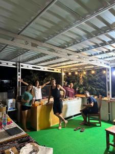 a group of people standing in front of a bar at WLA Homestay in Labuan Bajo +61 photos
