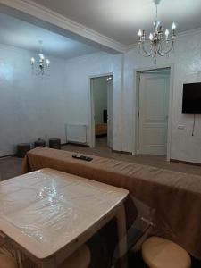 a large room with a table and a chandelier at Sunny Garden House in Ch'aisubani