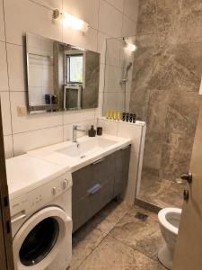 a bathroom with a sink and a washing machine at Luxury & Modern Apartment in Paralia Katerinis +16 photos