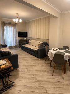 a living room with a couch and a table at Luxury & Modern Apartment in Paralia Katerinis