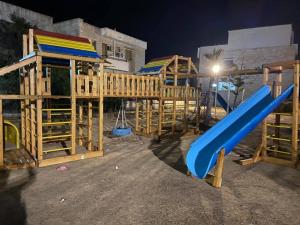 a playground with a blue slide and a slideintend at فيلا لؤلؤة كرير عائلات فقط أو بنات in Sidi Kirayr