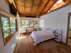 a bedroom with a bed and a television in it at Cabaña Baño de bosque in Coscotitlán