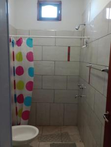 a bathroom with a shower with a sink and a toilet at Alojamientos Rinconcito don Antonio casa in Tinogasta +6 photos