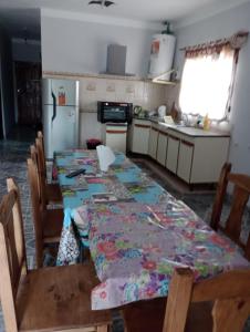 a kitchen with a table and chairs and a refrigerator at Alojamientos Rinconcito don Antonio casa in Tinogasta
