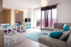 uma sala de estar com um sofá e uma mesa em Apartment Soni A4 em Krk