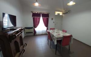 a dining room with a table and a window at Casa en La Punta in La Punta