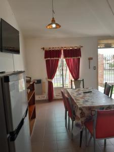 a kitchen and dining room with a table and chairs at Casa en La Punta in La Punta