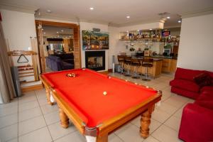 a living room with a red pool table in it at Thicker Than Water Vineyard - 4 Bedroom Pool in McLaren Vale