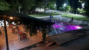 a swimming pool in a park at night at Finca campestre Wakanda in Doradal