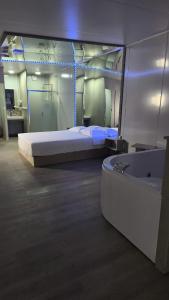 a room with a bed and a bath tub in it at Apartamento 201 in Colonia Valdense
