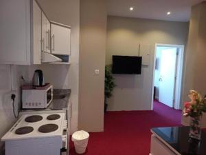 a kitchen with a stove and a microwave at Bue waves in Kuwait +18 photos